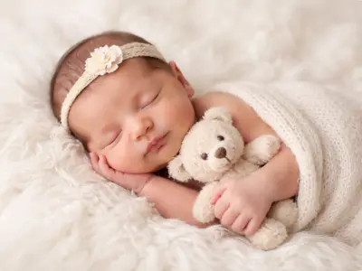 Sleeping baby with-teddy bear.webp